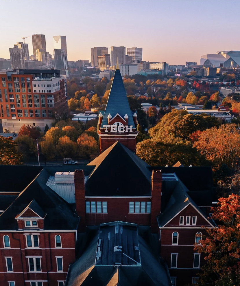 gt campus at dusk with the city in the background